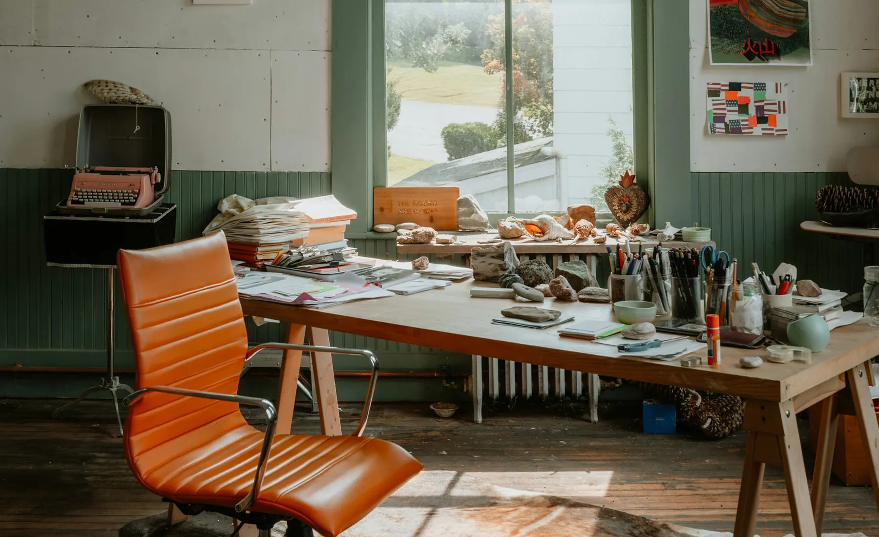 A creative studio with a long wooden desk